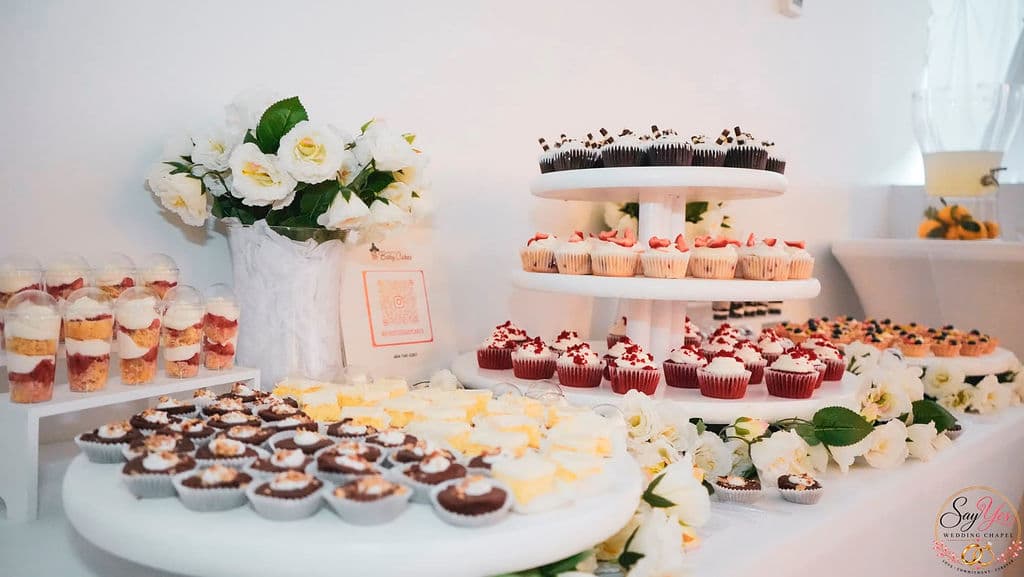 Dessert table with cupcakes, mini cheesecakes and dessert cups